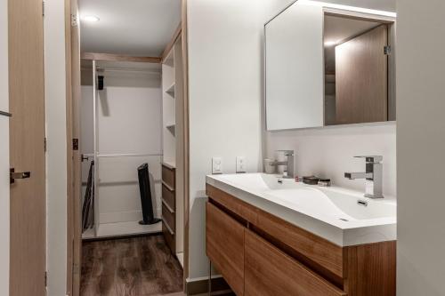 a bathroom with a sink and a mirror at Homero 1433, in Polanco by Blueground in Mexico City