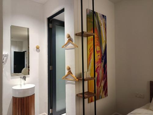 a bathroom with a sink and a mirror at T+ PREMIUM HOTEL in Alor Setar