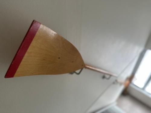 a wooden lamp on a wall next to a window at Maison Pi Mouss' à 150m de la mer in Cayeux-sur-Mer