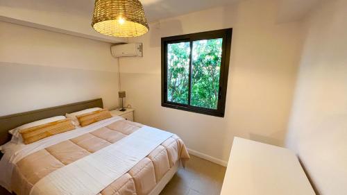 a bedroom with a bed and a window at VILLA MAGIC in Oyster Pond