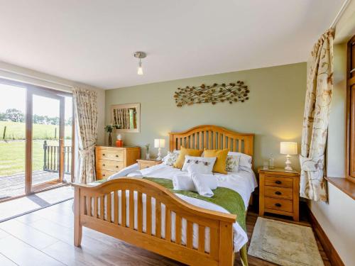 a bedroom with a large bed and a window at 1 Bed in South Molton OAKVI in South Molton