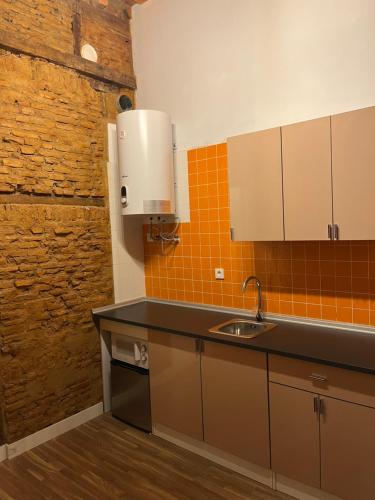 a kitchen with a sink and a counter top at Esencias de la Alhambra in Granada