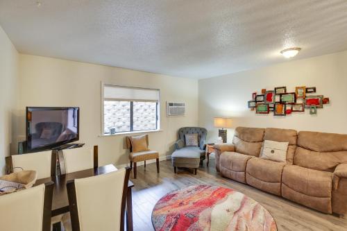 a living room with a couch and a tv at Walkable Lead Condo 5 Mi to Terry Peak Ski Area! in Lead