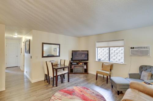 a living room with a table and a tv at Walkable Lead Condo 5 Mi to Terry Peak Ski Area! in Lead