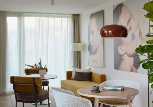 a living room with a couch and a table at ME Barcelona in Barcelona