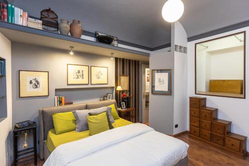 a bedroom with a bed with yellow pillows at Pantheon by Rental in Rome in Rome