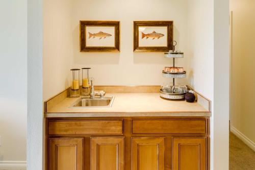 a kitchen with a sink and two pictures of fish on the wall at Beautiful Bigfork Condo with Hot Tub Access! in Bigfork