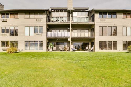 an apartment building with a lawn in front of it at Beautiful Bigfork Condo with Hot Tub Access! in Bigfork