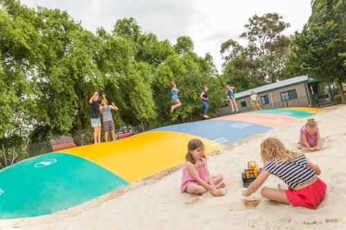 two little girls playing in the sand in the sandbox at NRMA Ballarat Holiday Park in Ballarat