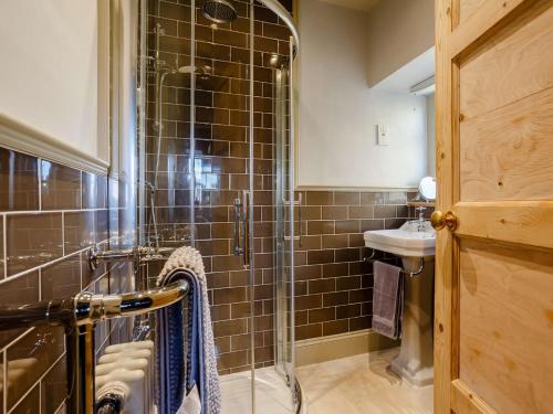 a bathroom with a glass shower and a sink at 2 Bed in Ardgay 88798 in Culrain