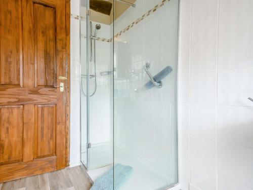 a shower with a glass door in a bathroom at 2 Bed in Bretforton 89476 in Bretforton
