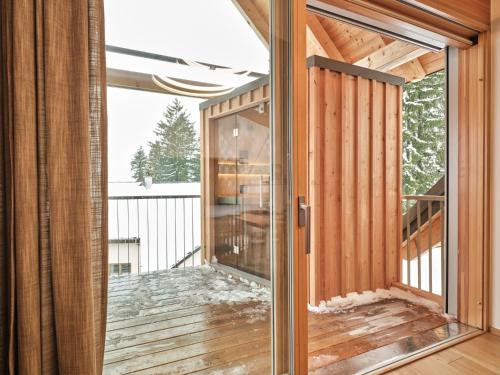 eine Glastür in einem Haus mit Balkon in der Unterkunft Mountain Lovers Three by AA Holiday Homes in Tauplitz