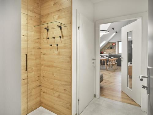 a pivot door in a home with wood paneling at Mountain Lovers Three by AA Holiday Homes in Tauplitz
