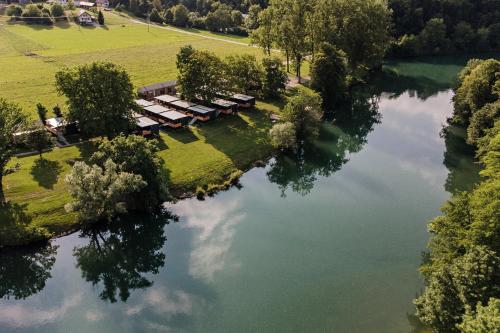 an aerial view of a lake with a group of houses at Glamping Lucky House in Gradac