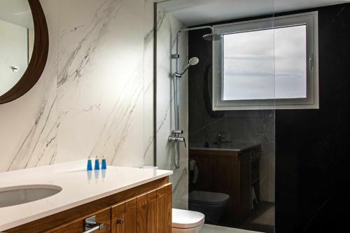 a bathroom with a sink and a toilet and a shower at Amor a Mar Starfish in Puerto del Carmen
