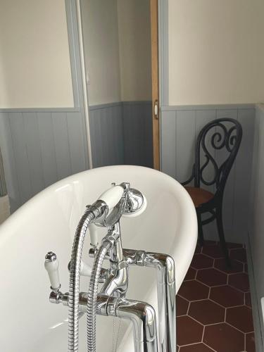 a bath tub with a faucet in a bathroom at Entre les branches in Saint-Règle
