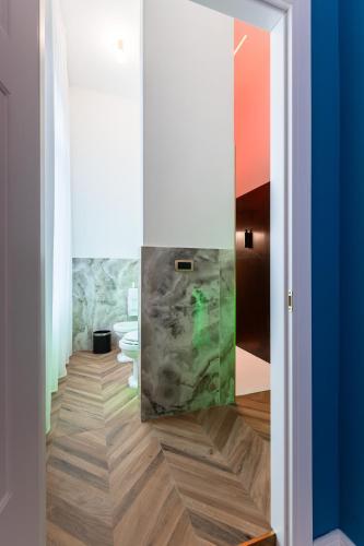 a bathroom with a marbleiled floor and toilets at Momento Soggiorno di Charme in Foggia