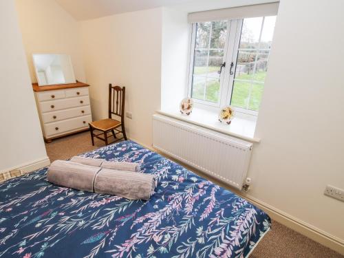 a bedroom with a bed and a window at Ty Gwyn in Welshpool