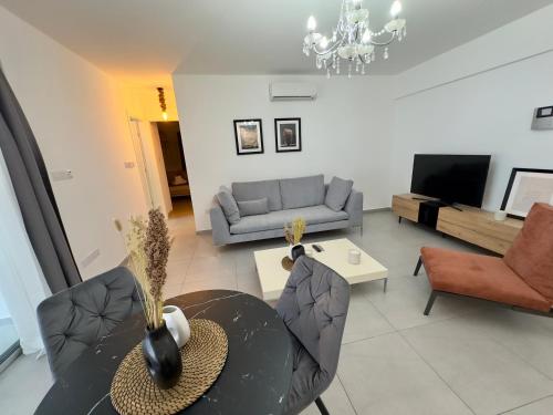 a living room with a table and a couch at Panorama Residence in Nicosia