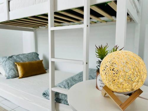 a white bunk bed with a pineapple on a table at Cozy Scandi home @ Balok! in Kampung Saberang Balok