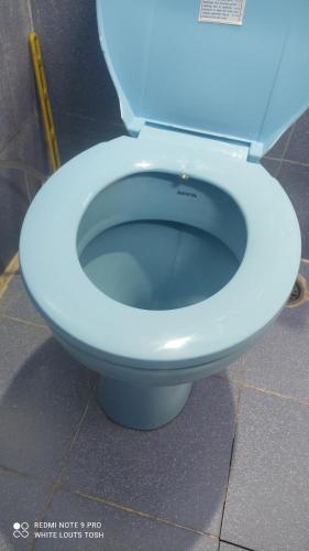 a white toilet seat with the seat up in a bathroom at White Lotus in Tosh הלוטוס הלבן -בטוש in Tosh