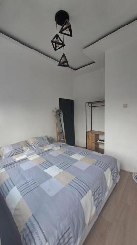 a bedroom with a large bed in a room at RENJANA BED AND BREAKFAST in Yogyakarta