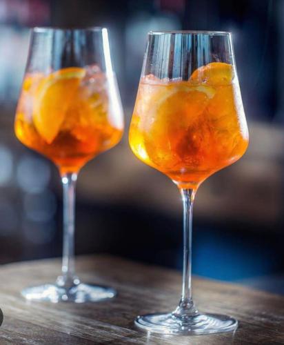 two glasses with oranges in them sitting on a table at The Green Inn in Goole