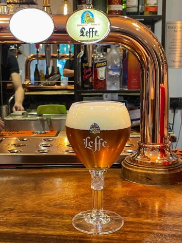 a glass of beer sitting on top of a bar at The Green Inn in Goole