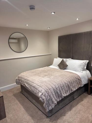 a bedroom with a large bed with a large mirror at The Green Inn in Goole