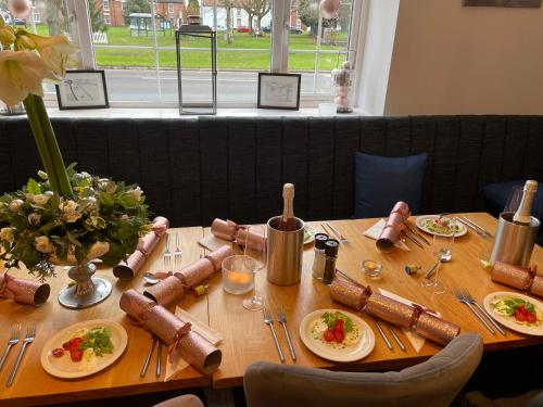 a wooden table with plates of food on it at The Green Inn in Goole