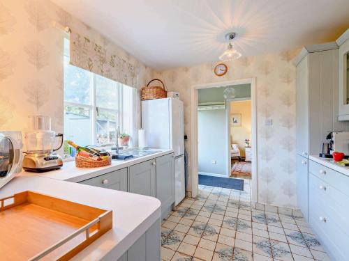 a kitchen with white cabinets and a counter top at 2 bed in Blandford Forum STOMI in Durweston
