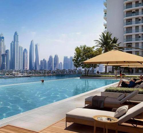 a swimming pool with a view of a city at Seaside Serenity Perfect Beachfront Holiday Haven in Dubai