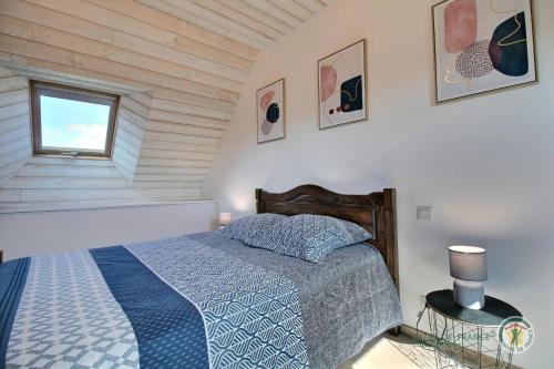 um quarto com uma cama e uma janela em La clef des champs em Kérien