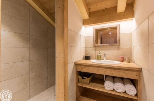 a bathroom with a sink and a mirror at Chalet Le Gypaète in Le Grand-Bornand