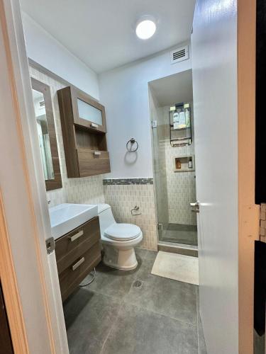 a bathroom with a toilet and a sink at Cimarron Suites Playa Parguito in El Cardón