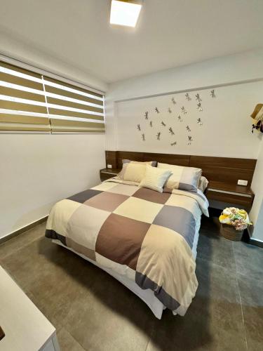 a bedroom with a large bed with birds on the wall at Cimarron Suites Playa Parguito in El Cardón