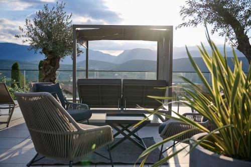 a patio with chairs and a table with a view at Das Panorama Dependance in Caldaro