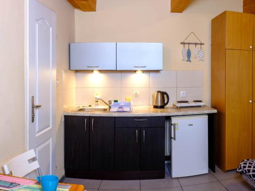 a kitchen with a sink and a counter top at Domki Ajna Park w uzdrowisku in Kołobrzeg