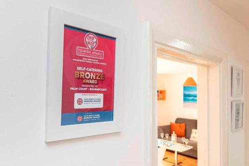 a framed poster on the wall of a living room at BOURNECOAST- NEAR TOWN CENTRE and BEACH with BEACH HUT - FM6114 in Bournemouth