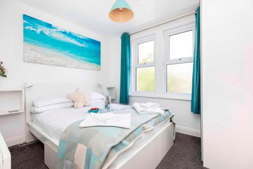 a bedroom with a bed and a window at BOURNECOAST- NEAR TOWN CENTRE and BEACH with BEACH HUT - FM6114 in Bournemouth