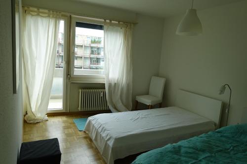 Säng eller sängar i ett rum på Basel Rooms Appartements