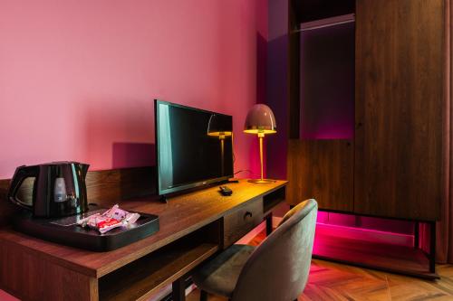 a room with a desk with a monitor and a chair at Momento Soggiorno di Charme in Foggia