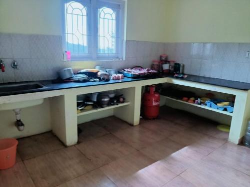 a kitchen with two counters and a sink in a room at Wander Valley in Ooty