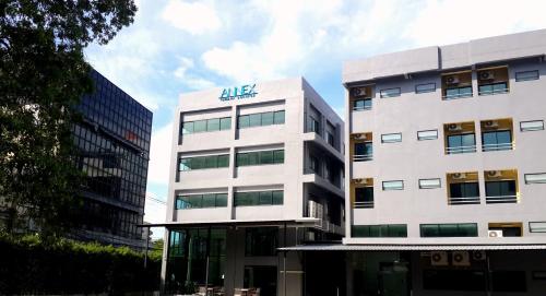 a large white building with an algas sign on it at Annex Lumpini Bangkok in Bangkok