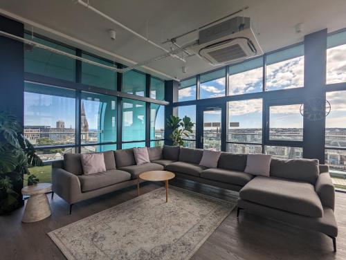 a living room with a couch and large windows at Aberdeen by Charles Hope in Aberdeen