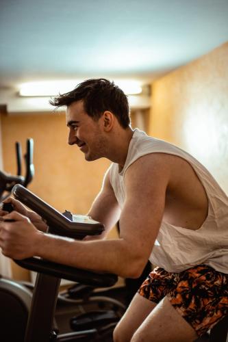 a man riding on a treadmill in a gym at Hotel Lamm Baiersbronn Mitteltal in Baiersbronn