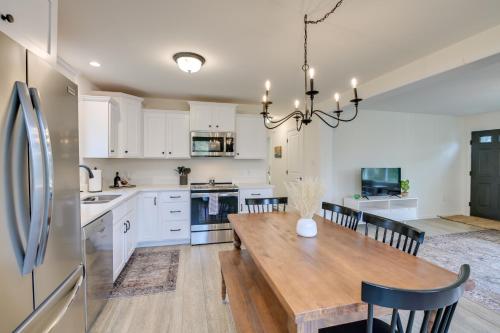 a kitchen and dining room with a wooden table at Ellsworth Vacation Rental with Fire Pit and Gas Grill! in Ellsworth