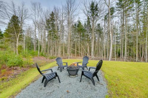 a group of chairs sitting around a fire pit at Ellsworth Vacation Rental with Fire Pit and Gas Grill! in Ellsworth
