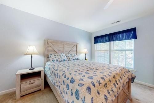 a bedroom with a bed and a window at Creekside --- 13 Hull Ln in Millville