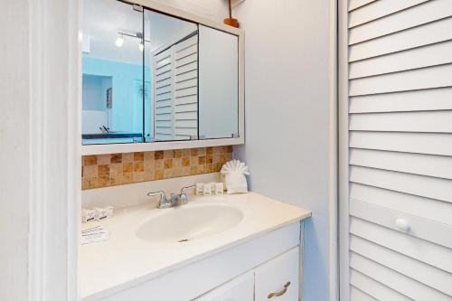 a bathroom with a sink and a mirror at Daytona Dreamin' Unit 320 in Daytona Beach